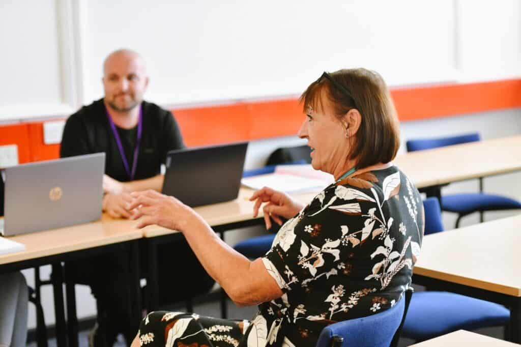 A lecturer addresses her class